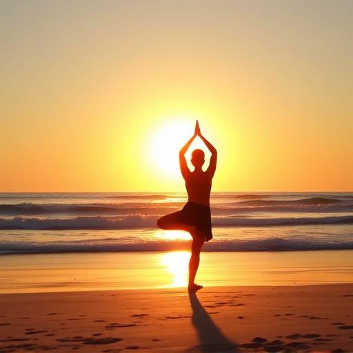 Person doing a yoga pose on a beach at sunset